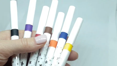 Multi-colored felt-tip pens close-up. Human hands are holding felt tip pens 動画素材 128440332