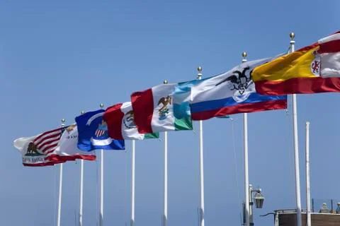 Multi-colored flags flying from pier in Santa Barbara, California Stock Photos