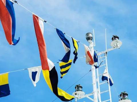 Multi colored flags mast of the ship. Flag decoration Stock Photos