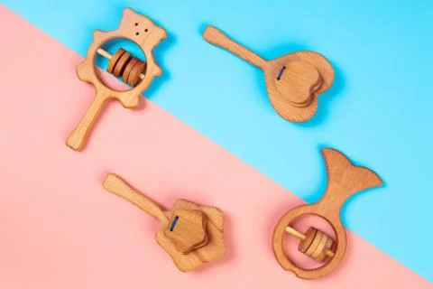 Multi-colored flat lay with eco-friendly wooden toys, rattles in the form of  Stock Photos