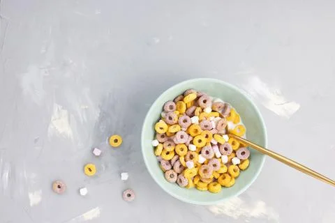 Multi colored fruit loops in a bowl with spoon Stock Photos