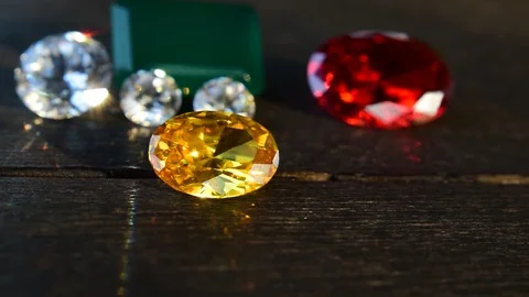 Multi colored gemstones Look beautiful on the wooden floor Stock Footage 121896917