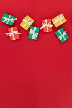 Multi-colored gifts on a red background. flat lay. christmas, birthday or hol Stock Photos