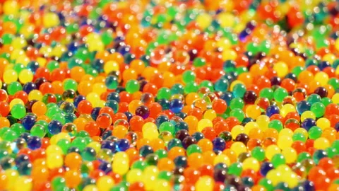 Multi-colored glass beads. Smooth rotation. Super magnification macro video Stock Footage 132665947