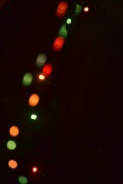 Multi-colored glow of the Christmas lights in the dark Stock Photos