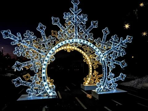Multi-colored glowing New Year's arch in the form of snowflakes Stock Photos