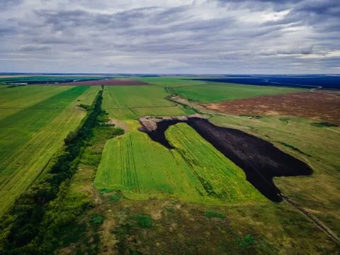 Multi-colored grain fields under a blue cloudy sky. photo from a quadrocopter Stock Photos