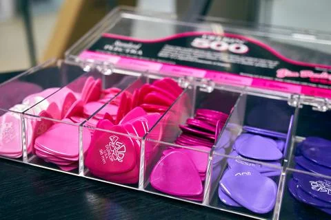 Multi-colored guitar picks in a music store Stock Photos