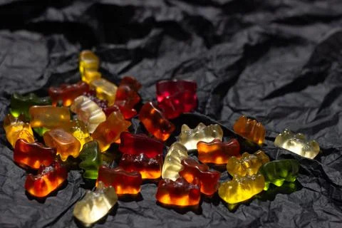 Multi-colored gummy bears lie in a chaotic manner Stock Photos