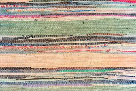 Multi-colored hand-made carpet from fabric. Stock Photos