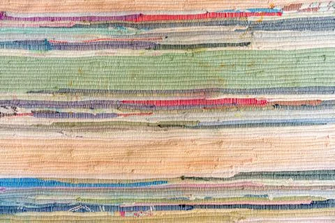 Multi-colored hand-made carpet from fabric. Stock Photos