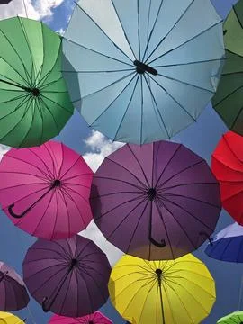Multi colored hanging umbrellas display Stock Photos