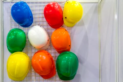 Multi-colored helmet hanging over the wall. Foto stock