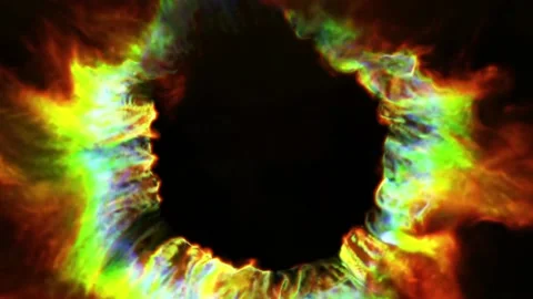 A multi-colored hoop of fire burns merrily against a black background, emitting Stock Footage 170529306
