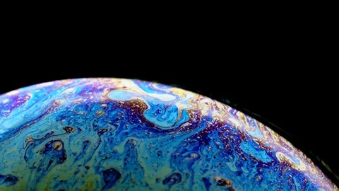 Multi-colored iris of a soap bubble in motion. black background. Stock Footage 114708779