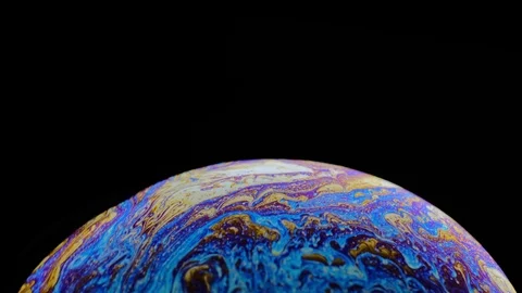 Multi-colored iris of a soap bubble in motion. black background. Stock Footage 114709077