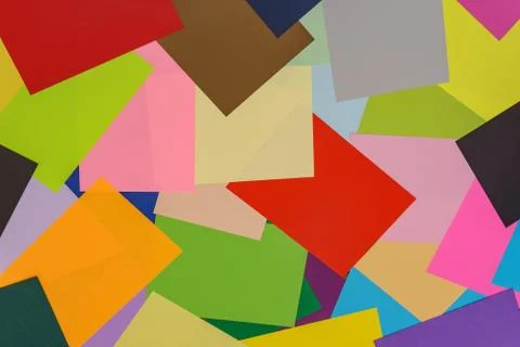 A multi-colored kaleidoscope of colored sheets of paper scattered chaotically in Stock Photos