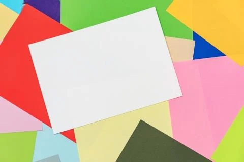 A multi-colored kaleidoscope of colored sheets of paper scattered chaotically in Foto stock