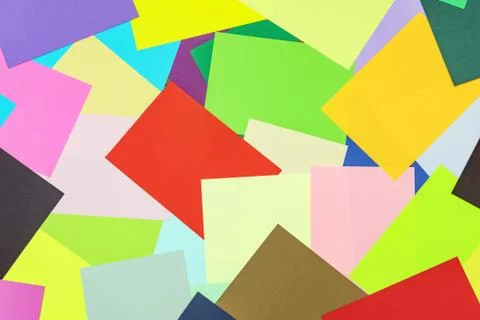 A multi-colored kaleidoscope of colored sheets of paper scattered chaotically in Foto stock