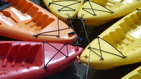 Multi-colored kayaks tied to each other near the shore. Stock Footage 138659074