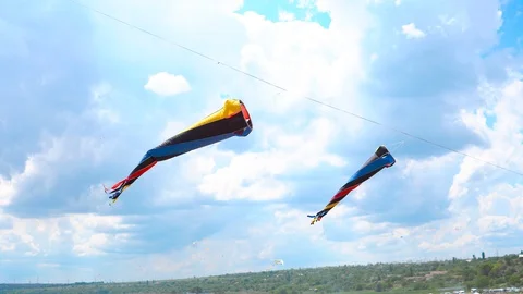 Multi-colored kites flying against the blue sky and clouds Stock Footage 90032902