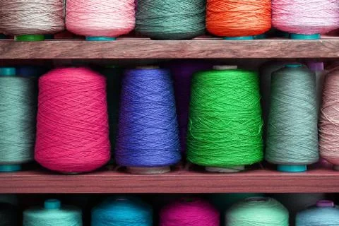 Multi-colored large spools of thread in a row. Spools of colored thread Stock Photos