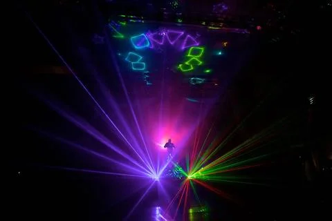 Multi-colored laser show in a dark space. Stock Photos