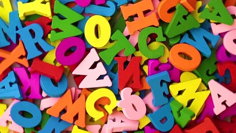 Multi-colored letters are scattered in a chaotic manner moving. Stock Footage 143522586