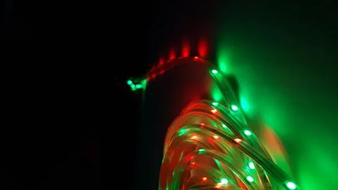 Multi-colored light system, garland, LED lamp on a dark background Stock Photos