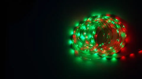 Multi-colored light system, garland, LED lamp on a dark background Stock Photos