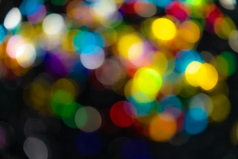 Multi-colored lights and black blurred bokeh background. Stock-Fotos