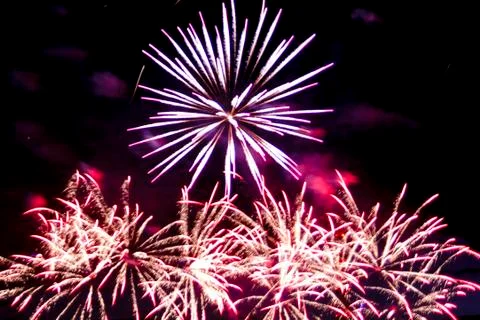 Multi-colored lights of a bright firework in the night sky. Stockfoto's