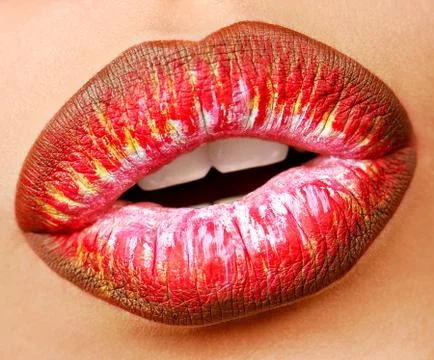 Multi colored lipstick with temptation gesture. Close-up lips. Macro shot. Stock Photos