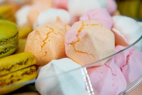 Multi-colored macaroons and meringues with cracks. Stock Photos