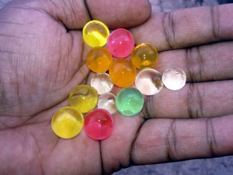 Multi colored marbel in a hand Foto stock