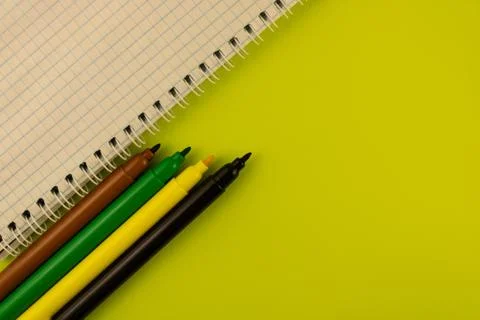 Multi-colored markers and a notebook on a spring Stock Photos