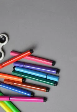Multi-colored markers on a gray background. Stock Photos