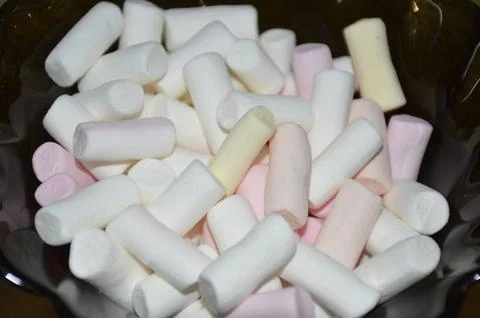 Multi-colored marshmallow dessert bars in a glass bowl, close-up Stock Photos