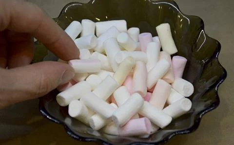Multi-colored marshmallow dessert bars in a glass bowl, close-up Stock Photos