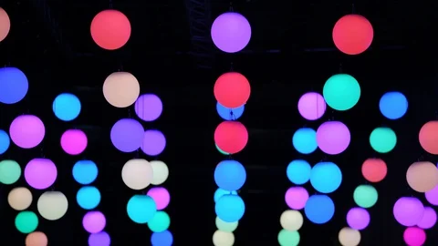 Multi colored moving spheres of light changing position and colour during nig Stock Footage 128400543