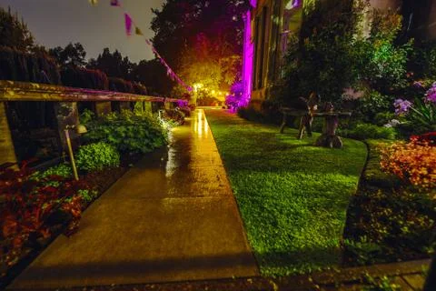 Multi-colored night lighting of the Scottish house garden. Stock Photos