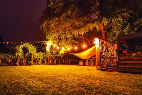 Multi-colored night lighting of the Scottish house garden. Stock Photos
