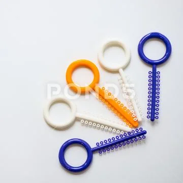 A multi-colored orthodontic ligatures for alignment of the orthodontist's tee Stock Photos