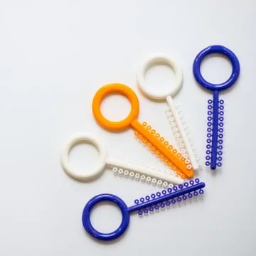 A multi-colored orthodontic ligatures for alignment of the orthodontist's tee Stock Photos