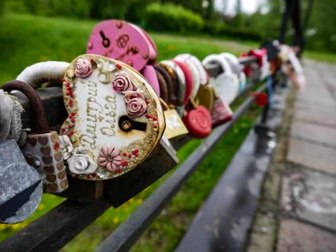 Multi-colored padlocks with missing keys on the bridge are symbols of fidelit Stock Photos