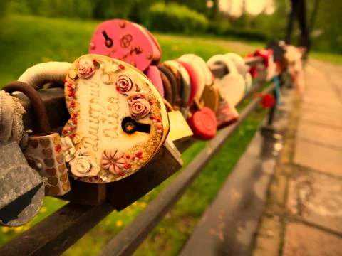 Multi-colored padlocks with missing keys on the bridge are symbols of fidelit Stock Photos