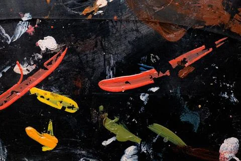Multi-colored paint strokes on black plastic as a background, brush strokes Stock Photos