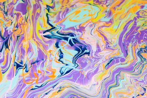 Multi-colored paints spilled on the table Stock Photos