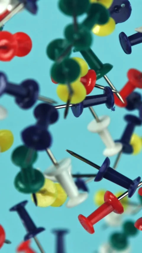 Multi-colored paper clips fly up and fall down. Filmed on a high-speed camera at Stock Footage 335380793