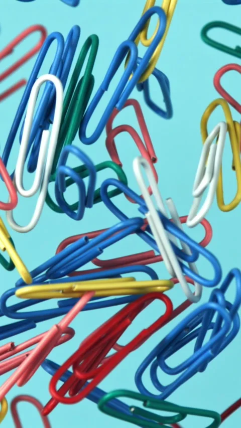 Multi-colored paper clips fly up and fall down. Filmed on a high-speed camera at Stock Footage 335384876